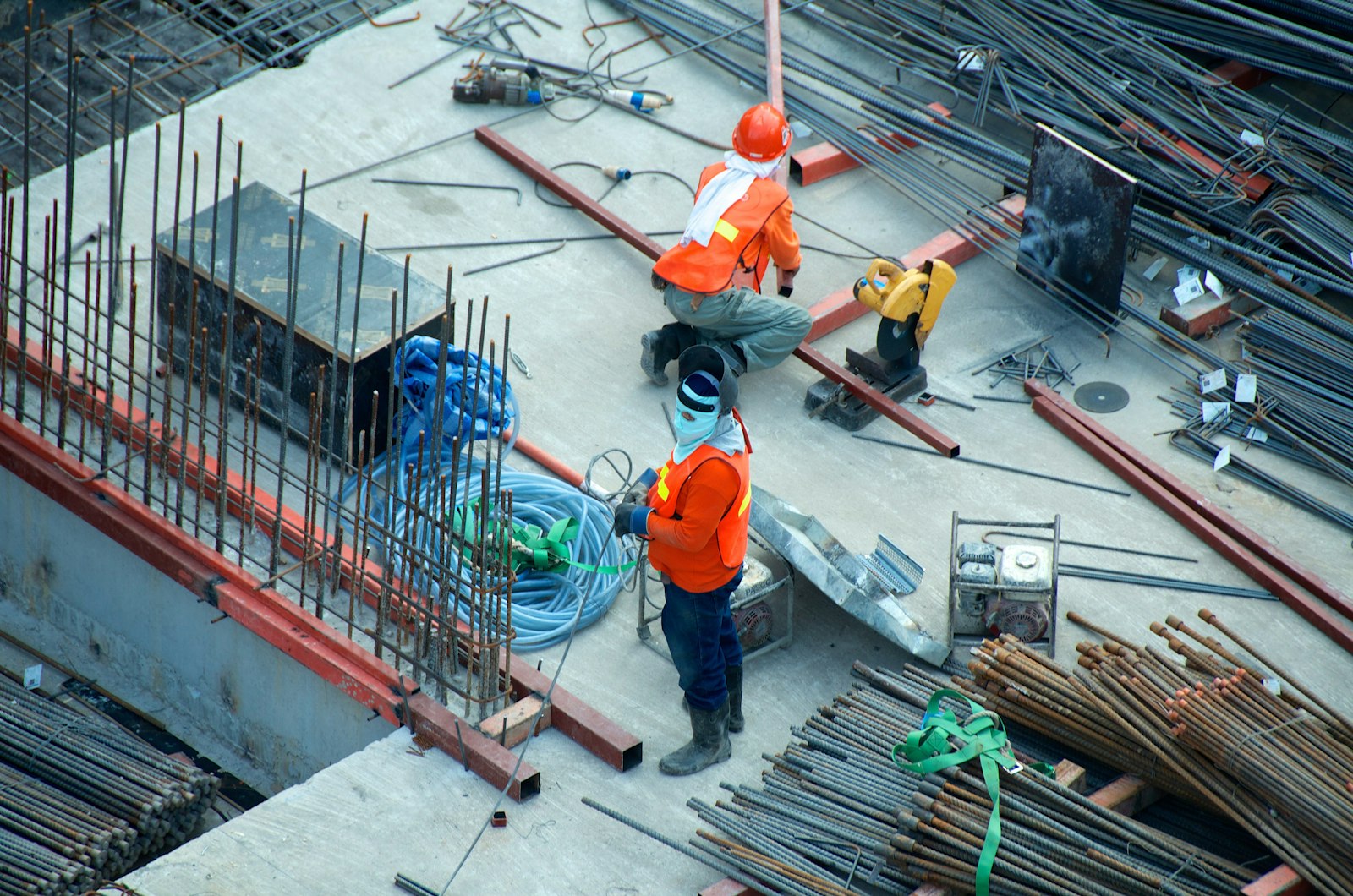 Crews placing steel and materials on a concrete deck
